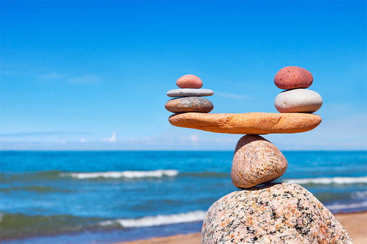 Work/life balance: balance stones against the sea