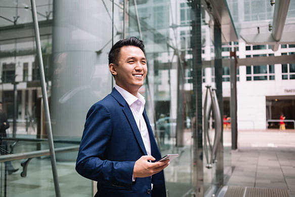 Sales & marketing executive using his phone.