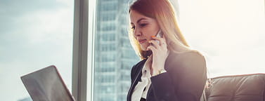 Young woman waiting in a hall sitting in modern office: how to follow up after an interview