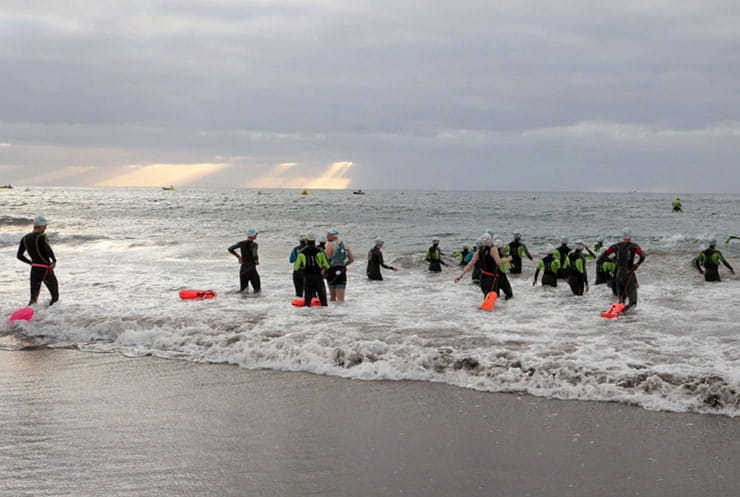 Triathletes entering the ocean.