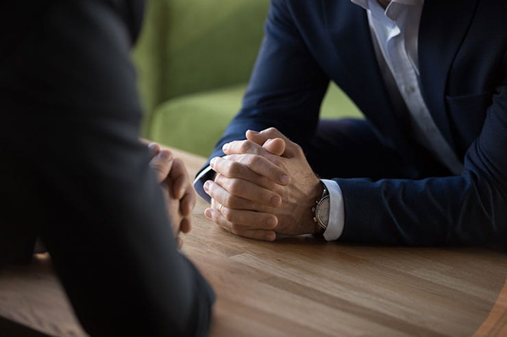 Businessmen in suits sit at the table opposite each other: interview questions and answers