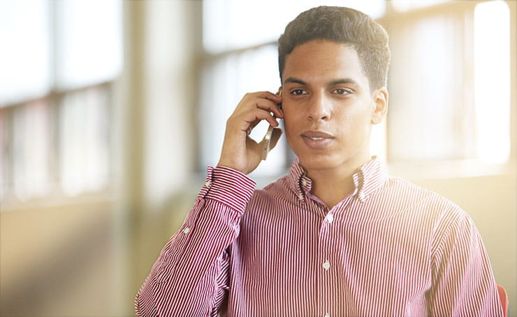 Young man having a phone interview: how to answer phone interview questions