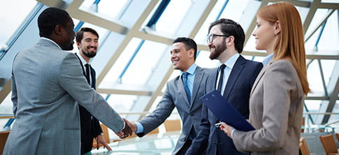 Group of professional workers smiling, handshake