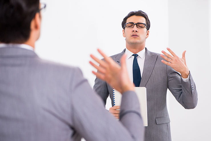 How do you answer phone interview questions? Young man planning speech in front of mirror