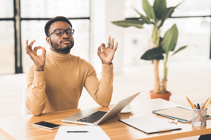 COVID-19 work from home motivation: man meditating during work