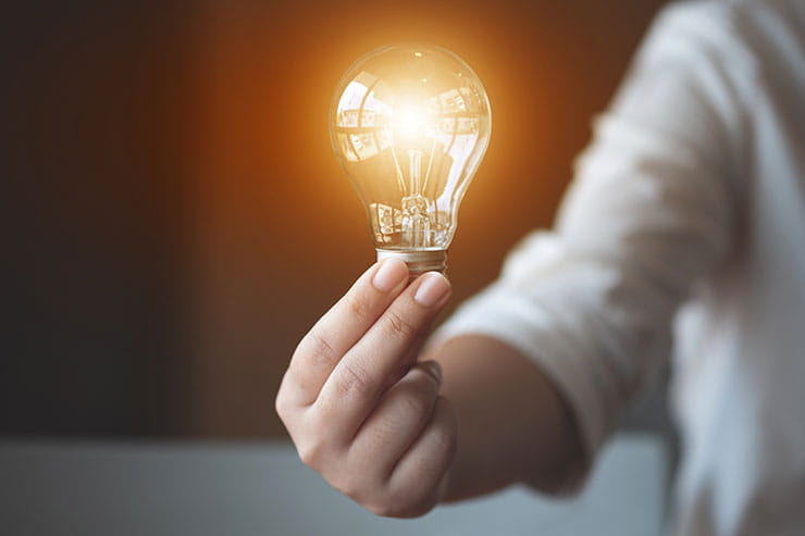 Hand holding a lightbulb