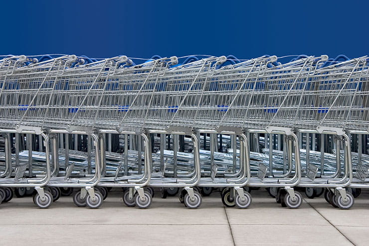 Line of shopping carts against blue background